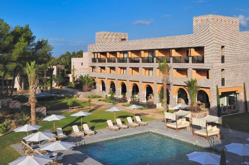 a resort with a pool and chairs and a building at Vincci Selección Estrella del Mar in Marbella
