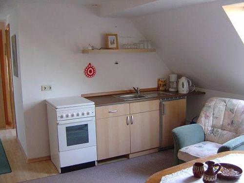 a small kitchen with a sink and a stove at Ferienwohnung-Domsuehl in Domsühl