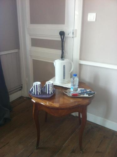 a small wooden table with a blender on top of it at O Mylle Douceurs in Le Crotoy
