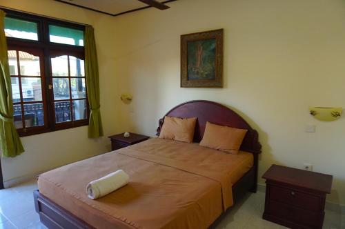 a bedroom with a large bed in a room at Yulia 2 Homestay Sanur in Sanur