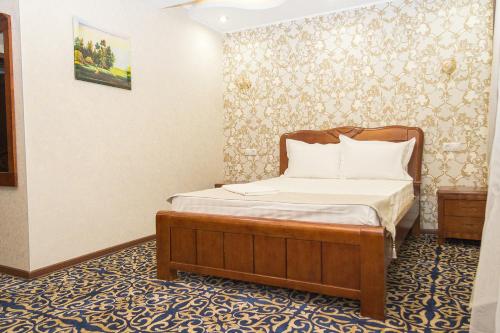 a bedroom with a bed in a room at Salut Hotel Almaty in Almaty