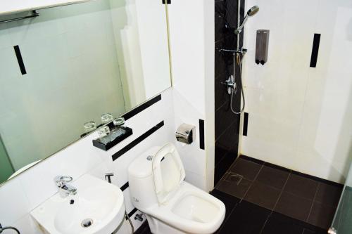 a bathroom with a toilet and a sink at Springz Hotel-Bukit Jalil in Kuala Lumpur