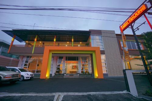 a building with a sign in front of it at The Cabin Tanjung Hotel Wonosobo in Wonosobo