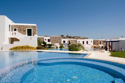 a swimming pool in front of a villa at Naxos Palace Hotel in Stelida