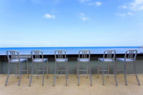 a group of chairs sitting at a table on the beach at Samui Resotel Beach Resort in Chaweng