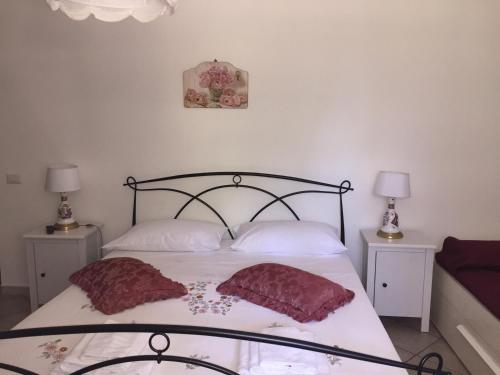 a bedroom with a bed with two pillows on it at Casale Del Borgo in Hermada