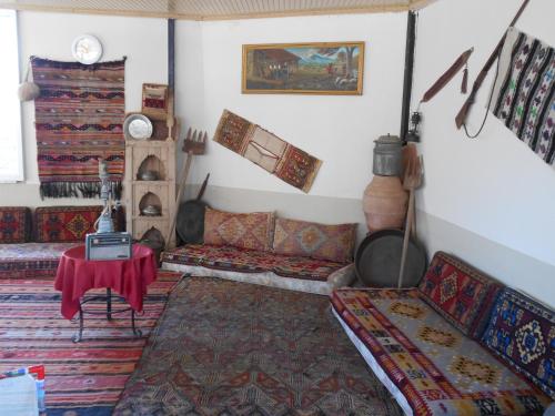 a living room with couches and a table in it at OzenTurku Hotel in Pamukkale
