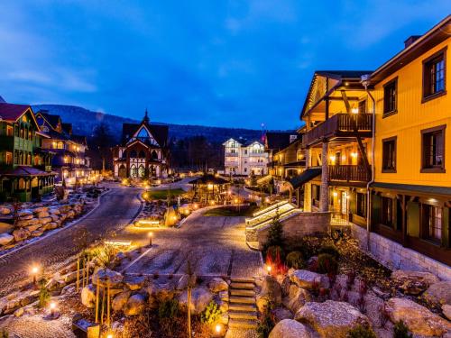 an old town at night with lights on the street at Norweska Dolina Family&Pet-friendly Resort in Szklarska Poręba
