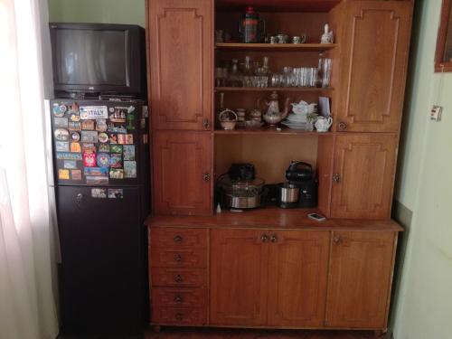 a kitchen with a refrigerator and a television in a room at Hostel in Batumi in Batumi