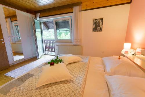 a bedroom with two beds and a balcony at Apartment Stefelin in Bled
