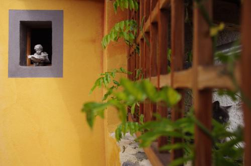 a statue of a child looking out of a window at Chez l'Autre in Chilhac