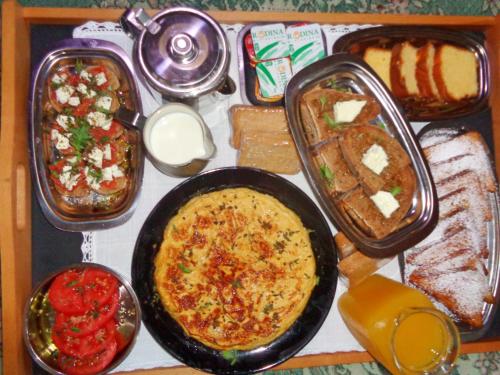a table with a pan of food and different types of food at Menina Farm Kalamata Countryside in Perivolákia