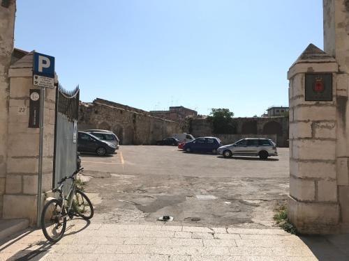 a bike parked next to a parking lot with cars at Casa Vacanze La Scalinata in Bisceglie