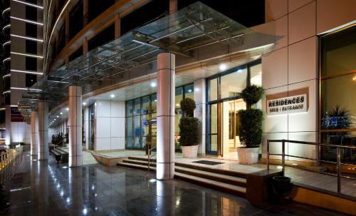 a lobby of a building with potted plants in it at Qafqaz Baku City Hotel & Residences in Baku