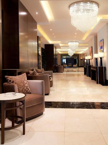 a lobby of a hotel with a couch and a table at Qafqaz Baku City Hotel & Residences in Baku
