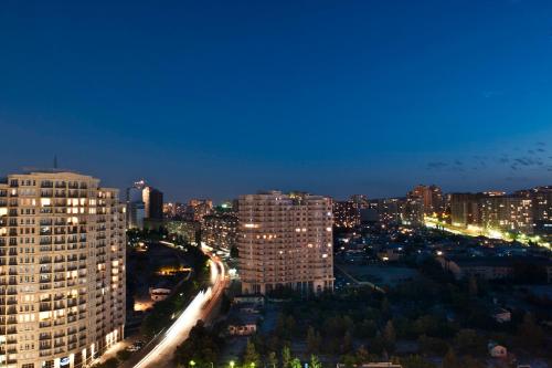a view of a city at night with buildings at Qafqaz Baku City Hotel & Residences in Baku