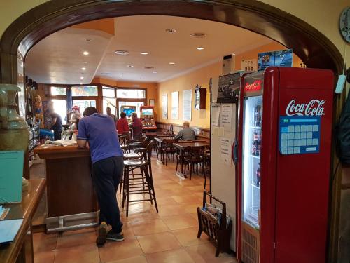 a man standing at a bar in a restaurant at Turó de L´Home in Santa María de Palautordera