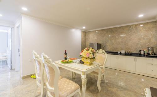 a kitchen and dining room with a table and chairs at Tan An Palace in Hai Phong