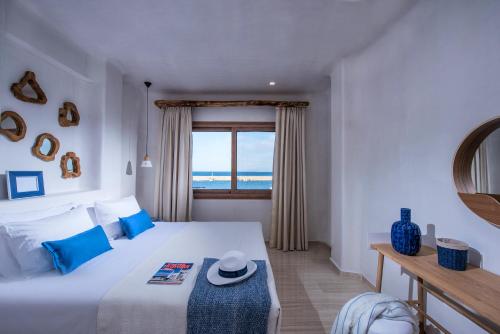 a bedroom with a bed with a view of the ocean at Cosmopolis Crete Suites in Hersonissos