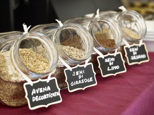 a row of glass jars filled with oats on a table at Casalgrande Hotel in Salvaterra