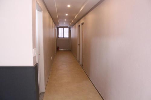 a hallway of an office building with a long corridor at Wood House Hotel in Busan