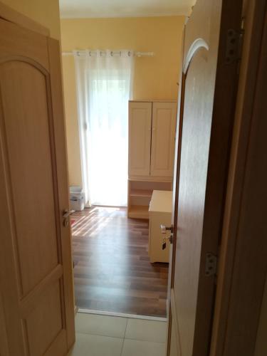 an open door to a kitchen with wooden floors at Cinema House Single & Double Rooms & Studio Apartments in Pula