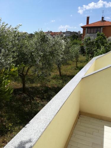 a view from the balcony of a house with trees at Cinema House Single & Double Rooms & Studio Apartments in Pula