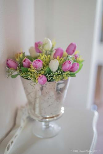 a vase filled with flowers sitting on a table at Villa "Piemonte" in Tigliole