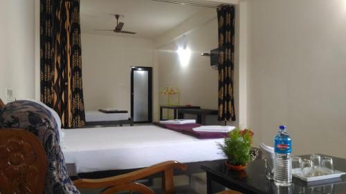 a bedroom with a bed with a large mirror at Skyrock Inn in Kattappana