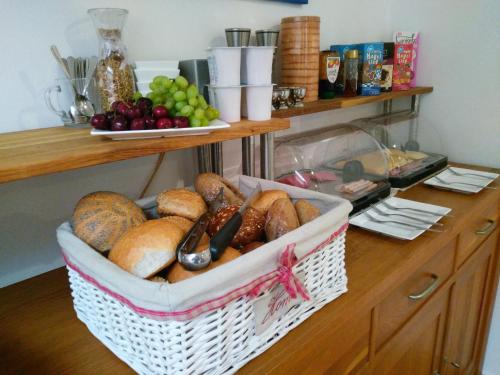 a basket of bread and fruit on a counter at Hotel De Wilde Kriek in Valkenburg