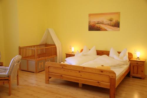 a bedroom with a bed and two candles on tables at Gasthaus Kerber in Fürstenstein