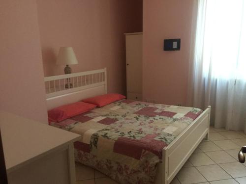 a bedroom with a bed with a quilt on it at Villarobinia in Lazise
