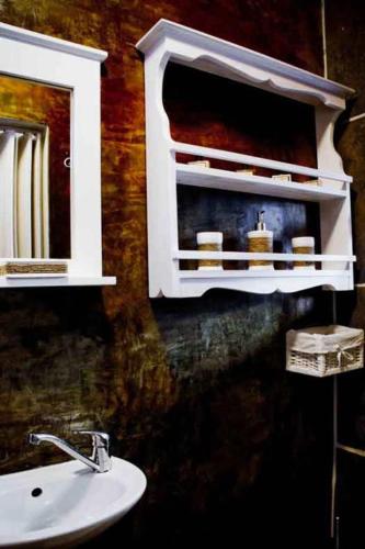 a bathroom with a sink and a mirror at a Vue Guesthouse in Somerset West