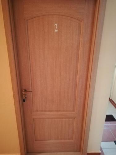 a wooden door with the number two on it at Cinema House Single & Double Rooms & Studio Apartments in Pula