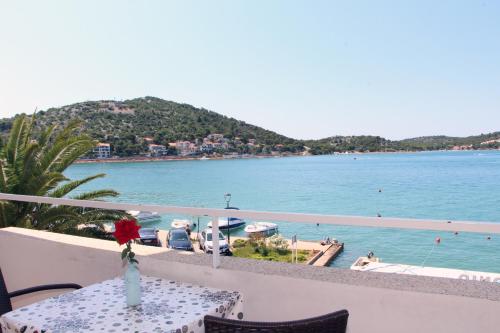 a view of the water from the balcony of a resort at Apartments Antonio in Tisno