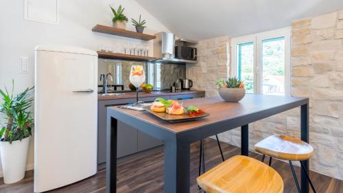 a kitchen with a table with a bowl of fruit on it at Kalavanda Apartment in Hvar