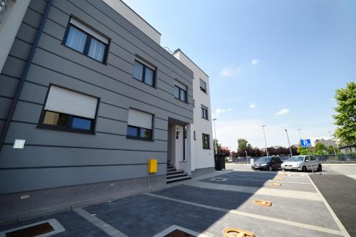 a building with a car parked in a parking lot at Precko7NEW in Zagreb