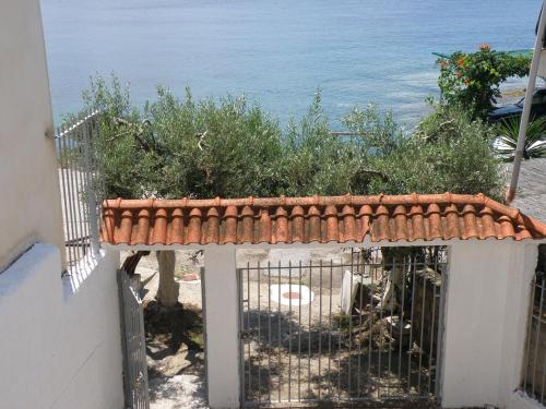 a gate to a house with the ocean in the background at Seaside Villa in Neos Marmaras
