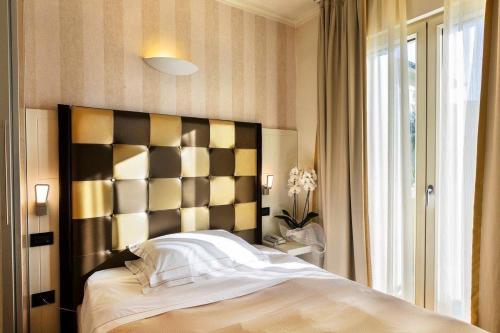 a bedroom with a large bed and a window at JR Resort Logos Forte dei Marmi in Forte dei Marmi