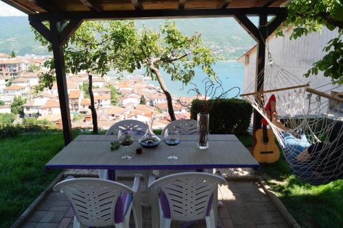 a blue table and chairs on a patio with a view at Snegar Apartments in Ohrid