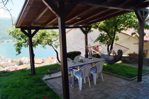 a table and chairs under a pergola on a patio at Snegar Apartments in Ohrid