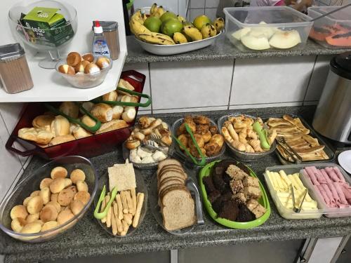 a buffet of different types of food on a counter at Pousada Castelinho in Caldas Novas