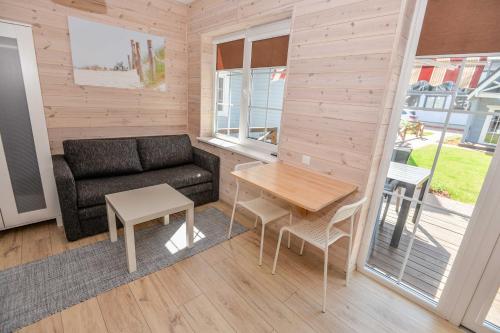 a living room with a couch and a table at Ošupio Vasarnamis in Šventoji