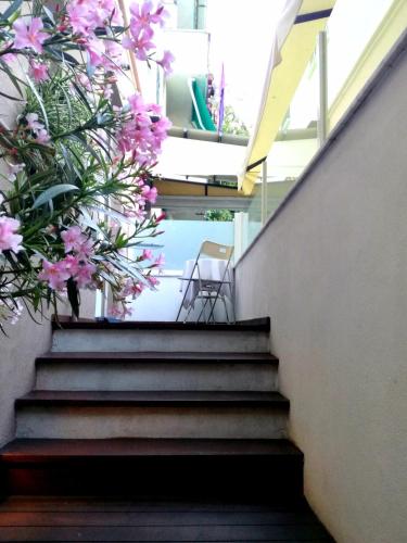 a set of stairs with pink flowers on them at MA Hotel in Santa Margherita Ligure