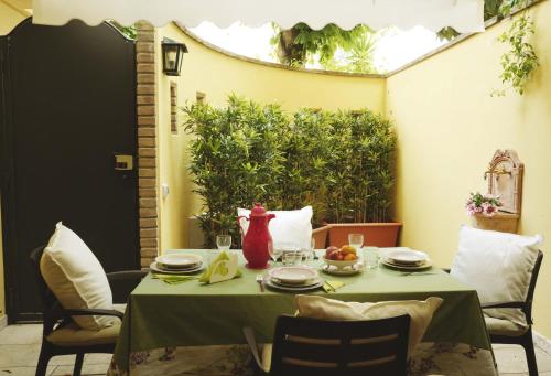 a table with a green table cloth and a vase on it at Sweet Central appartment in San Benedetto del Tronto