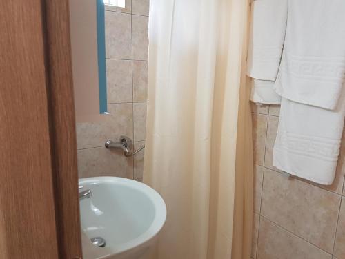 a bathroom with a white sink and a toilet at Villa Xani in Himare