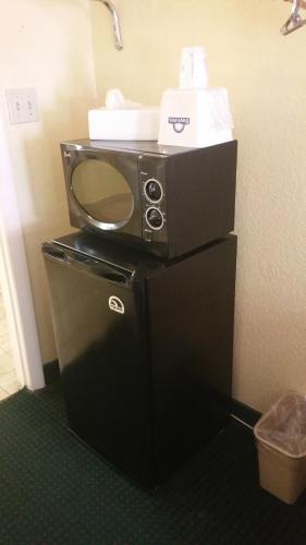 a microwave sitting on top of a table in a room at Days Inn by Wyndham Cocoa Cruiseport West At I-95/524 in Cocoa