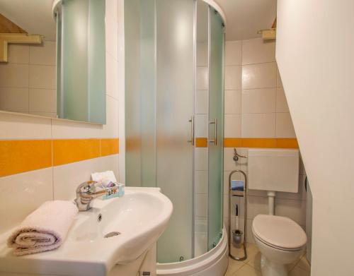 a bathroom with a sink and a toilet at Karla Apartment in Labin