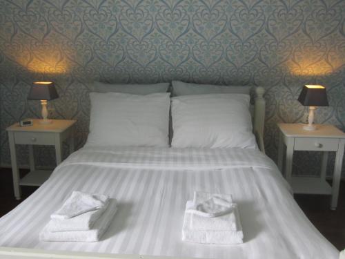 Een bed of bedden in een kamer bij B&B De Gouden Vlo