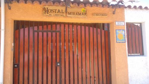 a wooden door with a sign on top of it at Hostal Miramar in Valparaíso